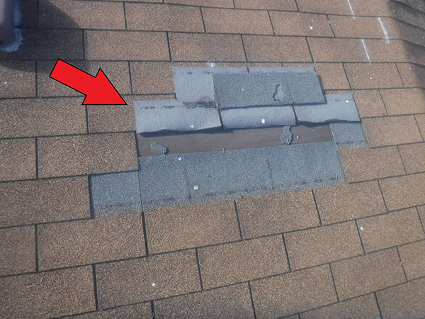 Wind damage to roof shingles